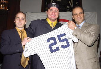 398611 03: Baseball player Jason Giambi poses with Yankees General Manager Brian Cashman (L) and Manager Joe Torre (R) at Yankee Stadium to announce Giambis signing with the New York Yankees December 13, 2001 in New York. Giambi is the American Leagues Most Valuable Player in 2000 and runner up in 2001. (Photo by Lawrence Lucier/Getty Images)
