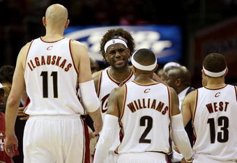 CLEVELAND - MAY 20:  LeBron James #23 reacts after a play with teammates Zydrunas Ilgauskas #11, Mo Williams #2 and Delonte West #13 of the Cleveland Cavaliers against the Orlando Magic in Game One of the Eastern Conference Finals during the 2009 Playoffs at Quicken Loans Arena on May 20, 2009 in Cleveland, Ohio. NOTE TO USER: User expressly acknowledges and agrees that, by downloading and or using this photograph, User is consenting to the terms and conditions of the Getty Images License Agreement  (Photo by Elsa/Getty Images)