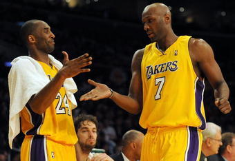 LOS ANGELES, CA - DECEMBER 01:  Lamar Odum #7 of the Los Angeles Lakers is greeted by Kobe Bryant #24 as he leaves the game leading the New Orleans Hornets during the fourth quarter at Staples Center on December 1, 2009 in Los Angeles, California. NOTE TO USER: User expressly acknowledges and agrees that, by downloading and/or using this Photograph, user is consenting to the terms and conditions of the Getty Images License Agreement.  (Photo by Harry How/Getty Images)