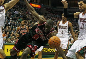 MILWAUKEE - NOVEMBER 30: Luol Deng #9 of the Chicago Bulls is fouled as he moves between Andrew Bogut #6 and Carlos Delfino #10 of the Milwaukee Bucks at the Bradley Center on November 30, 2009 in Milwaukee, Wisconsin. NOTE TO USER: User expressly acknowledges and agrees that, by downloading and/or using this Photograph, User is consenting to the terms and conditions of the Getty Images License Agreement. (Photo by Jonathan Daniel/Getty Images)
