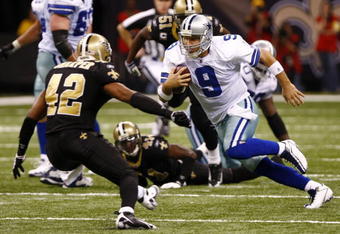 NEW ORLEANS - DECEMBER 19:  Quarterback Tony Romo #9 of the Dallas Cowboys scrambles with the ball as safety Darren Sharper #42 of the New Orleans Saints looks to tackle him at the Louisiana Superdome on December 19, 2009 in New Orleans, Louisiana. (Photo by Scott Halleran/Getty Images)