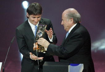 ZURICH - SWITZERLAND - DECEMBER 21:  Argentina's Lionel Messi receives the 2009 FIFA World Player Trophy from UEFA President Michel Platini and FIFA President Sepp Blatter during the FIFA World Player Gala 2009 at the Kongresshaus on December 21, 2009 in Zurich, Switzerland.  (Photo by Pascal Muller/Getty Images)