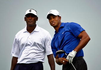 CHASKA, MN - AUGUST 15:  Tiger Woods watches his tee shot on the first hole as Vijay Singh of Fiji looks on during the third round of the 91st PGA Championship at Hazeltine National Golf Club on August 15, 2009 in Chaska, Minnesota.  (Photo by Streeter Lecka/Getty Images)