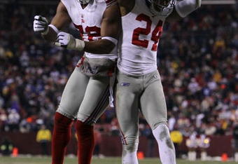 LANDOVER, MD - DECEMBER 21:  (R-L) Terrell Thomas #24 of the New York Giants and Osi Umenyiora #72 celebrate after Thomas scored on an interception return for a touchdown in the third quarter against  the Washington Redskins at FedEx Field on December 21, 2009 in Landover, Maryland. (Photo by Al Bello/Getty Images)