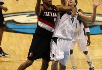 DALLAS - FEBRUARY 04: LaMarcus Aldridge #12 of the Portland Trail Blazers takes a shot against Dirk Nowitzki #21 of the Dallas Mavericks on February 4, 2009 at American Airlines Center in Dallas, Texas.  NOTE TO USER: User expressly acknowledges and agrees that, by downloading and/or using this Photograph, user is consenting to the terms and conditions of the Getty Images License Agreement.  (Photo by Ronald Martinez/Getty Images)