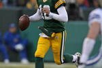 GREEN BAY, WI - NOVEMBER 15: Aaron Rodgers #12 of the Green Bay Packers rolls out to look for a receiver against the Dallas Cowboys at Lambeau Field on November 15, 2009 in Green Bay, Wisconsin. The Packers defeated the Cowboys 17-7. (Photo by Jonathan Daniel/Getty Images)