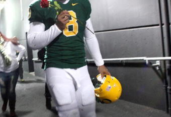 EUGENE, OR - DECEMBER 3:  Quarterback Jeremiah Masoli #8 of the Oregon Ducks celebrates their Civil War victory over Oregon State holding a rose at Autzen Stadium on December 3, 2009 in Eugene, Oregon. The Ducks defeated the Beavers 37-33. (Photo by Tom Hauck/Getty Images)