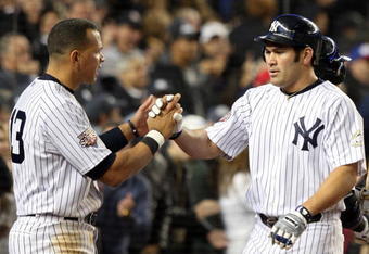 NEW YORK - NOVEMBER 04:  Alex Rodriguez #13 of the New York Yankees congratulates Johnny Damon #18 after Damon scored in a 2-run single by Hideki Matsui #55 in the bottom of the third inning against the Philadelphia Phillies in Game Six of the 2009 MLB World Series at Yankee Stadium on November 4, 2009 in the Bronx borough of New York City.  (Photo by Jed Jacobsohn/Getty Images)