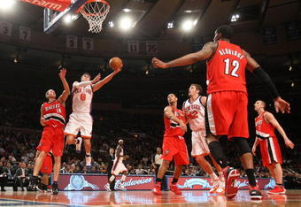 NEW YORK - DECEMBER 07:  Danilo Gallinari #8 of the New York Knicks lays the ball up against Joel Pryzbilla #10 of the Portland Trail Blazers at Madison Square Garden on December 7, 2009 in New York, New York. NOTE TO USER: User expressly acknowledges and agrees that, by downloading and/or using this Photograph, user is consenting to the terms and conditions of the Getty Images License Agreement.  (Photo by Nick Laham/Getty Images)