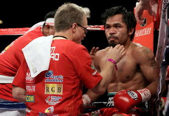 LAS VEGAS - NOVEMBER 14:  Manny Pacquiao sits in his corner between rounds with trainer Freddie Roach against Miguel Cotto during their WBO welterweight title fight at the MGM Grand Garden Arena on November 14, 2009 in Las Vegas, Nevada.  (Photo by Al Bello/Getty Images)