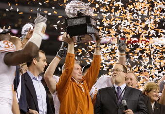ARLINGTON, TX - DECEMBER 5: Head coach Mack Brown of the Texas Longhorns lifts the trophy after his teams 10-6 victory over the Nebraska Cornhuskers in the game at Cowboys Stadium on December 5, 2009 in Arlington, Texas. (Photo by Jamie Squire/Getty Images)