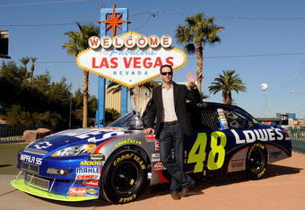 LAS VEGAS - DECEMBER 02:  2009 NASCAR Sprint Cup Series Champion Jimmie Johnson poses with the trophy next to the #48 Lowe's Chevrolet during Day 1 of the NASCAR Sprint Cup Series Champions Week on December 2, 2009 in Las Vegas, Nevada.  (Photo by Rusty Jarrett/Getty Images for NASCAR)