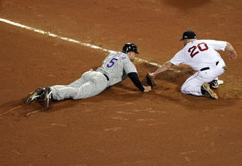 BOSTON - OCTOBER 25:  Matt Holliday #5 of the Colorado Rockies is picked off by Kevin Youkillis #20 of the Boston Red Sox during Game Two of the 2007 Major League Baseball World Series against the Boston Red Sox at Fenway Park on October 25, 2007 in Boston, Massachusetts.  (Photo by Jed Jacobsohn/Getty Images)