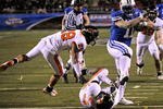 LAS VEGAS - DECEMBER 22:  Manase Tonga #11 of the Brigham Young University Cougars gets by Suaesi Tuimaunei #28 and Anthony Watkins #47 of the Oregon State Beavers en route to scoring a touchdown in the fourth quarter of the MAACO Las Vegas Bowl at Sam Boyd Stadium December 22, 2009 in Las Vegas, Nevada. The Cougars won 44-20.  (Photo by Ethan Miller/Getty Images)