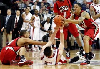 LAS VEGAS - MARCH 12:  Ryan Amoroso #43 of the San Diego State Aztecs tries to keep the ball from Rene Rougeau #24 and Tre'Von Willis #33 of the UNLV Rebels during a quarterfinal game of the Conoco Mountain West Conference Basketball Championships at the Thomas & Mack Center March 12, 2009 in Las Vegas, Nevada. The Aztecs won 71-57.  (Photo by Ethan Miller/Getty Images)