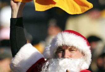 PITTSBURGH - DECEMBER 24:  A  Pittsburgh Steelers fan dressed up as Santa Claus swings his teams colors during the game against the Baltimore Ravens on December 24, 2006 at Heinz Field in Pittsburgh, Pennsylvania.  (Photo by Chris McGrath/Getty Images)