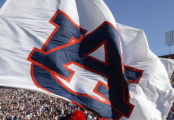 LOS ANGELES - SEPTEMBER 2:  The cheer team of the Auburn Tigers race out onto the field with the team flag bearer leading the way before the game against the USC Trojans on September 2, 2002 at the Los Angeles Coliseum in Los Angeles, California.  USC defeated Auburn 24-17.  (Photo by Stephen Dunn/Getty Images)