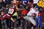 LANDOVER, MD - DECEMBER 21:  Steve Smith #12 of the New York Giants catches a six-yard touchdown pass against Justin Tryon #20 of the Washington Redskins in the second quarter at FedEx Field on December 21, 2009 in Landover, Maryland. (Photo by Al Bello/Getty Images)
