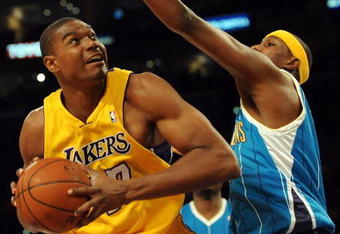 LOS ANGELES, CA - DECEMBER 01:  Andrew Bynum #17 of the Los Angeles Lakers looks to the basket as he is guarded by Julain Wright #32 of the New Orleans Hornets at Staples Center on December 1, 2009 in Los Angeles, California.  (Photo by Harry How/Getty Images) NOTE TO USER: User expressly acknowledges and agrees that, by downloading and/or using this Photograph, user is consenting to the terms and conditions of the Getty Images License Agreement.