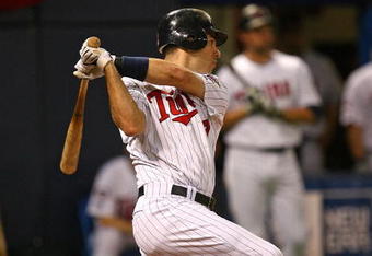 MINNEAPOLIS - OCTOBER 11: Joe Mauer #7 of the Minnesota Twins hits a run-scoring single in the 6th inning against the New York Yankees in Game Three of the ALDS during the 2009 MLB Playoffs at the Hubert H. Humphrey Metrodome on October 11, 2009 in Minneapolis, Minnesota. (Photo by Jonathan Daniel/Getty Images)