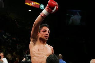 LAS VEGAS - SEPTEMBER 16:  Israel Vazquez celebrates after defeating Jhonny Gonzalez after their WBC super bantamweight titile fight at the MGM Grand Garden Arena September 16, 2006 in Las Vegas, Nevada. Vazquez retained his title after defeating Gonzalez by TKO in the 10th round.  (Photo by Ethan Miller/Getty Images)