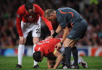 MANCHESTER, UNITED KINGDOM - APRIL 29:  Rio Ferdinand of Manchester United receives attention after sustaining an injury during the UEFA Champions League Semi Final First Leg match between Manchester United and Arsenal at Old Trafford on April 29, 2009 in Manchester, England. (Photo by Shaun Botterill/Getty Images)