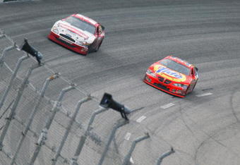 DARLINGTON, SC - MARCH 16:  Eventual winner Ricky Craven, driver of the #32 Tide Pontiac, passes Kurt Busch, driver of the #97 Rubbermain Ford, on the final lap of the NASCAR Carolina Dodge Dealers 400 on March 16, 2003 at Darlington Raceway in Darlington, South Carolina. (Photo by Jamie Squire/Getty Images)