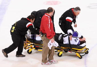 GLENDALE, AZ - DECEMBER 26: Justin Williams #14 of the Los Angeles Kings is helped off the ice on a stretcher after being injured in the first period of the the NHL game against the Phoenix Coyotes at Jobing.com Arena on December 26, 2009 in Glendale, Arizona.  (Photo by Christian Petersen/Getty Images)