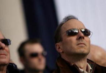 NEW YORK - NOVEMBER 6:  General Manager Brian Cashman (C) of the New York Yankees stands for the National Anthem during the Yankees World Series victory celebration on the steps of City Hall November 6, 2009 in New York City.  (Photo by Michael Appleton-Pool/Getty Images)