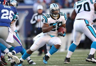 EAST RUTHERFORD, NJ - DECEMBER 27: Jonathan Stewart #28 of the Carolina Panthers rushes against the New York Giants at Giants Stadium on December 27, 2009 in East Rutherford, New Jersey.  (Photo by Nick Laham/Getty Images)