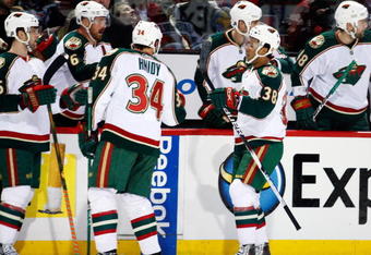 MONTREAL- DECEMBER 17:  Robbie Earl #38 of the Minnesota Wild celebrates his first period goal with team mates during the NHL game against the Montreal Canadiens on December 17, 2009 at the Bell Centre in Montreal, Quebec, Canada.  (Photo by Richard Wolowicz/Getty Images)