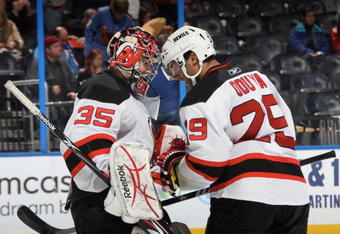 ATLANTA - DECEMBER 19: Yann Danis #35 of the New Jersey Devils celebrates with Johnny Oduya #29 after the game against the Atlanta Thrashers at Philips Arena on December 19, 2009 in Atlanta, Georgia. (Photo by Scott Cunningham/NHLI via Getty Images)
