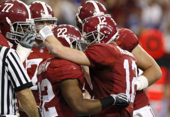 ATLANTA - DECEMBER 5:  Mark Ingram #22 and quarterback Greg McElroy #12 of the Alabama Crimson Tidecelebrate after Ingram scored a 7-yard rushing touchdown in the first quarter against the Florida Gators during the SEC Championship game at Georgia Dome on December 5, 2009 in Atlanta, Georgia.  (Photo by Kevin C. Cox/Getty Images)