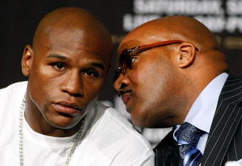 LAS VEGAS - SEPTEMBER 16:  Boxer Floyd Mayweather Jr. (L) and his advisor Leonard Ellerbe confer during the final news conference for Mayweather's bout against Juan Manuel Marquez at the MGM Grand Hotel/Casino September 16, 2009 in Las Vegas, Nevada. Mayweather and Marquez will fight at the MGM Grand Garden Arena on September 19 in Las Vegas.  (Photo by Ethan Miller/Getty Images)