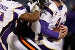 CHICAGO - DECEMBER 28: Brett Favre #4 of the Minnesota Vikings is sacked by Alex Brown #96 of the Chicago Bears as Bryant McKinnie #74 tries to stop him at Soldier Field on December 28, 2009 in Chicago, Illinois. The Bears defeated the Vikings 36-30 in overtime. (Photo by Jonathan Daniel/Getty Images)