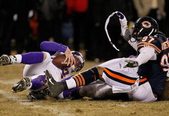 CHICAGO - DECEMBER 28: Mark Anderson #97 of the Chicago Bears waves a hand-warmer at Brett Favre #4 of the Minnesota Vikings after a sack at Soldier Field on December 28, 2009 in Chicago, Illinois. The Bears defeated the Vikings 36-30 in overtime. (Photo by Jonathan Daniel/Getty Images)