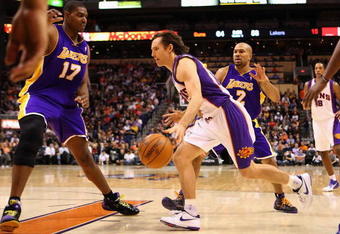 PHOENIX - DECEMBER 28:  Steve Nash #13 of the Phoenix Suns drives the ball past  Derek Fisher #2 of the Los Angeles Lakers during the NBA game at US Airways Center on December 28, 2009 in Phoenix, Arizona.  The Suns defeated the Lakers 118-103. NOTE TO USER: User expressly acknowledges and agrees that, by downloading and or using this photograph, User is consenting to the terms and conditions of the Getty Images License Agreement.  (Photo by Christian Petersen/Getty Images)