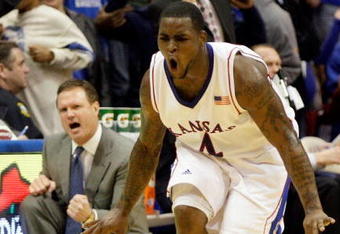 LAWRENCE, KS - DECEMBER 22:  Sherron Collins #4 of the Kansas Jayhawks reacts after sinking a three-pointer as head coach Bill Self looks on during the game against the California Golden Bears on December 22, 2009 at Allen Fieldhouse in Lawrence, Kansas.  (Photo by Jamie Squire/Getty Images)