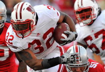 COLUMBUS, OH - OCTOBER 10:  Running back John Clay #32 of the Wisconsin Badgers hops away from the grasp of Ross Homan #51 of the Ohio State Buckeyes at Ohio Stadium on October 10, 2009 in Columbus, Ohio.  (Photo by Jamie Sabau/Getty Images)