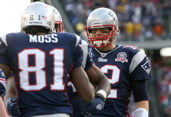 FOXBORO, MA - DECEMBER 27: Randy Moss #81 of the New England Patriots is congratulated by team mate Tom Brady #12 after catching his third touchdown pass of the day against the Jacksonville Jaguars in the fourth quarter at Gillette Stadium on December 27, 2009 in Foxboro, Massachusetts. (Photo by Jim Rogash/Getty Images)