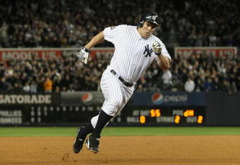 NEW YORK - NOVEMBER 04:  Johnny Damon #18 of the New York Yankees rounds third and scores in the bottom of the third inning against the Philadelphia Phillies in Game Six of the 2009 MLB World Series at Yankee Stadium on November 4, 2009 in the Bronx borough of New York City.  (Photo by Nick Laham/Getty Images)