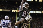 EAST RUTHERFORD, NJ - JANUARY 4:  Santana Moss #83 of the New York Jets is lifted in celebration by teammate Wayne Chrebet #80 after Moss scored a touchdown against the Indianapolis Colts during the AFC wildcard game at Giants Stadium on January 4, 2003 in East Rutherford, New Jersey.  The Jets won 41-0.  (Photo by Al Bello/Getty Images)