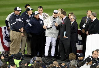 NEW YORK - NOVEMBER 04:  Manager Joe Girardi of the New York Yankees is interviewed as he celebrates with the trophy after their 7-3 win against the Philadelphia Phillies in Game Six of the 2009 MLB World Series at Yankee Stadium on November 4, 2009 in the Bronx borough of New York City.  (Photo by Al Bello/Getty Images)