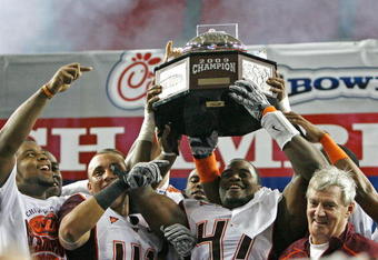 ATLANTA - DECEMBER 31:  Linebacker Cam Martin #41 and defensive end Nekos Brown #47 of the Virginia Tech Hokies hold the championship trophy as head coach Frank Beamer looks on after the Chick-Fil-A Bowl against the Tennessee Volunteers at the Georgia Dome on December 31, 2009 in Atlanta, Georgia.  The Hokies beat the Volunteers 37-14.  (Photo by Mike Zarrilli/Getty Images)