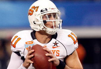 ARLINGTON, TX - JANUARY 02:  Quarterback Zac Robinson #11 of the Oklahoma State Cowboys drops back to pass against the Mississippi Rebels during the AT&T Cotton Bowl on January 2, 2010 at Cowboys Stadium in Arlington, Texas.  (Photo by Ronald Martinez/Getty Images)