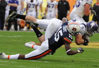 TAMPA, FL - JANUARY 1: Defensive back Neiko Thorpe #15 of the Auburn Tigers tackles split back Drake Dunsmore #9 of the Northwestern Wildcats in the Outback Bowl January 1, 2010 at Raymond James Stadium in Tampa, Florida.  (Photo by Al Messerschmidt/Getty Images)