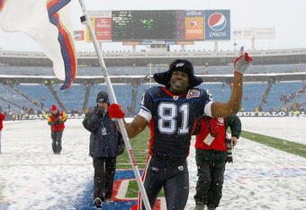 ORCHARD PARK, NY - JANUARY 03: Terrell Owens #81 of the Buffalo Bills runs off the field with a Bills flag after the Bills defeated the Indianapolis Colts at Ralph Wilson Stadium on January 3, 2010 in Orchard Park, New York. Buffalo won 30-7. (Photo by Rick Stewart/Getty Images)