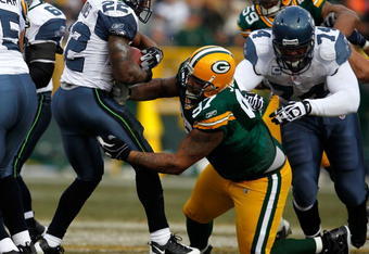 GREEN BAY, WI - DECEMBER 27: Johnny Jolly #97 of the Green Bay Packers tackles Julius Jones #22 of the Seattle Seahawks at Lambeau Field on December 27, 2009 in Green Bay, Wisconsin. The Packers defeated the Seahawks 48-10. (Photo by Jonathan Daniel/Getty Images)