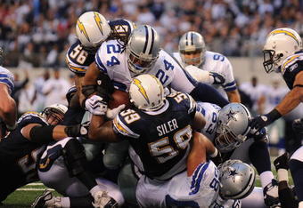 ARLINGTON, TX - DECEMBER 13:  Running back Marion Barber #24 of the Dallas Cowboys is tackled at the goal line by Brandon Siler #59 of the San Diego Chargers at Cowboys Stadium on December 13, 2009 in Arlington, Texas.  (Photo by Ronald Martinez/Getty Images)