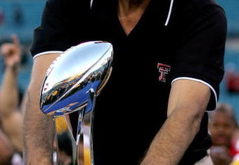 JACKSONVILLE, FL - JANUARY 01:  Coach Mike Leach of the Texas Tech Red Raiders holds the trophy following Gator Bowl against the Virginia Cavaliers at Jacksonville Municipal Stadium on January 1, 2008 in Jacksonville, Florida.  (Photo by Sam Greenwood/Getty Images)